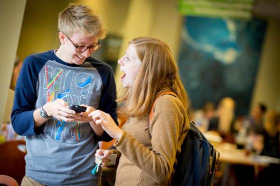 Photo of two Chatham University students looking at a phone together